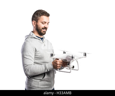 Man holding drone. Studio shot on white background, isolated Stock Photo