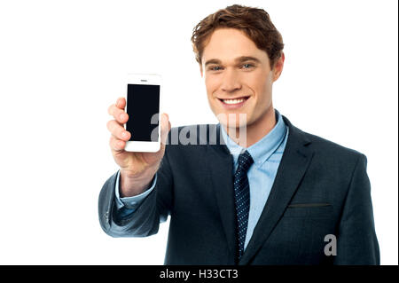 Salesman displaying newly launched mobile Stock Photo