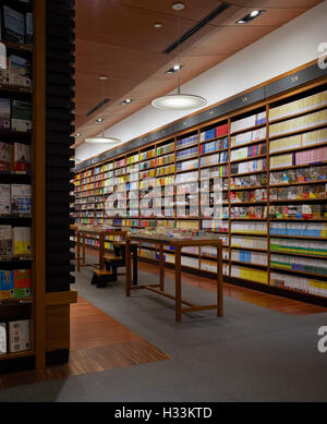 Perspective with display shelving. Kinokuniya EmQuartier Bangkok, Bangkok, Thailand. Architect: Kay Ngee Tan Architects, 2016. Stock Photo