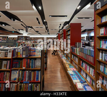 Folded ceiling feature and display shelves. Kinokuniya EmQuartier Bangkok, Bangkok, Thailand. Architect: Kay Ngee Tan Architects, 2016. Stock Photo