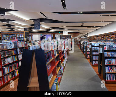 Folded ceiling feature and book display. Kinokuniya EmQuartier Bangkok, Bangkok, Thailand. Architect: Kay Ngee Tan Architects, 2016. Stock Photo