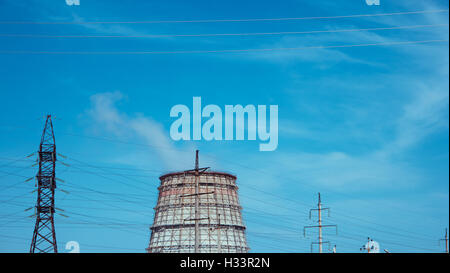 Smoking chimneys against the blue colorized sky Stock Photo