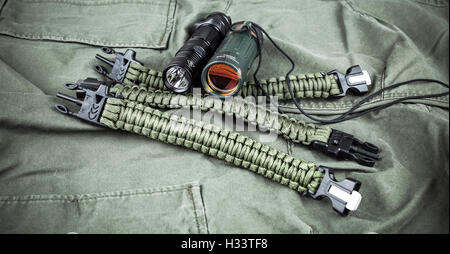 Military paracord bracelet, tactical torch and spy-glass Stock Photo