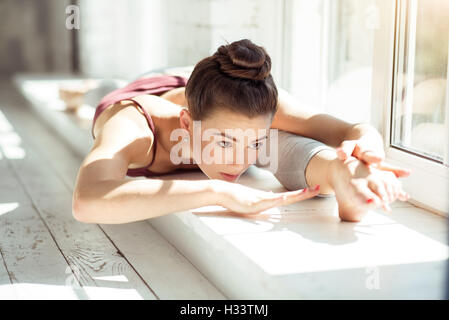 Skillful young woman doing the splits Stock Photo