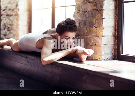 Serious confident woman doing the splits Stock Photo