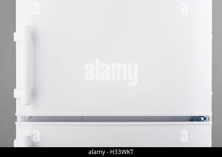 White refrigerator on gray background Stock Photo