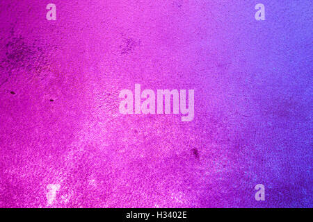 Details of a skin texture of a tambourine, illuminated from back by blue and pink lights. Stock Photo
