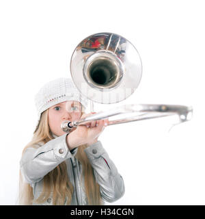 young girl with cap playing trombone Stock Photo