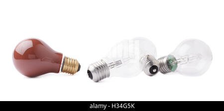 Red bulb lying next to couple of transparent bulbs over white isolated background Stock Photo