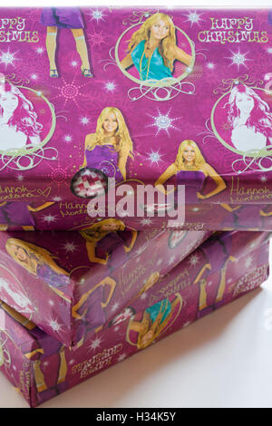 Christmas shoeboxes wrapped in Hannah Montana Happy Christmas wrapping paper for charity for children not so privileged Stock Photo