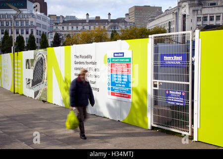 PPE illustration Health and Safety signage hoardings, PPE signs, personal protective equipment, safety footwear, hard hats, eye protection,  workers safe. Hearing Protection Signs. Hard Hat Signs. Foot Protection Signs. Eye Protection Signs, & fencing around construction and infrastructure site,  part of Piccadilly Gardens as a substantial programme of repair to the water feature, Piccadilly Gardens fountain, Manchester, UK Stock Photo