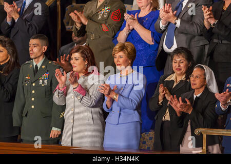 WASHINGTON, DC, USA - First Lady Laura Bush, center, listens to her husband President George W. Bush delivering his State of the Union speech before Congress on February 2, 2005. Stock Photo