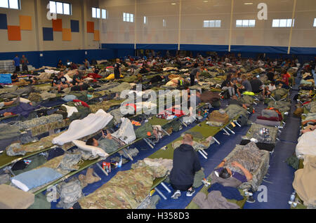 Guantanamo Bay, Cuba. 4th October, 2016. U.S. service members pack into the Denich Gym set up as an emergency shelter at Joint Task Force Guantanamo Bay in preparation for Hurricane Matthew October 4, 2016 in Guantanamo Bay, Cuba. Hurricane Matthew, a Category 4 storm with maximum sustained wind speeds of 145 mph and wind gusts of 170 mph slammed into the central Caribbean causing widespread damage. Credit:  Planetpix/Alamy Live News Stock Photo