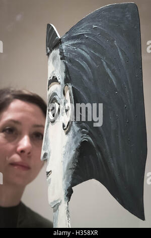 London, UK. 5th October, 2016. Picasso sculpture: Jacqueline with a Yellow Ribbon (1962) posed with a gallery staff member. National Portrait Gallery opening of ‘Picasso Portaits’ exhibition which focuses on the portraits of people he knew Credit:  Guy Corbishley/Alamy Live News Stock Photo