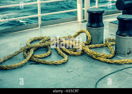 rope on a deck of ship in the sea Stock Photo