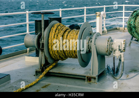 winch on a deck of ship in the sea Stock Photo