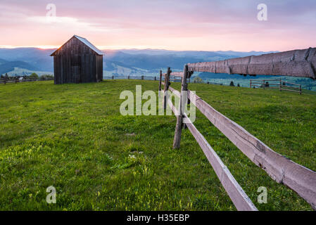 Rural Romanian landscape at sunrise in the Bukovina Region (Bucovina), Paltinu, Romania Stock Photo
