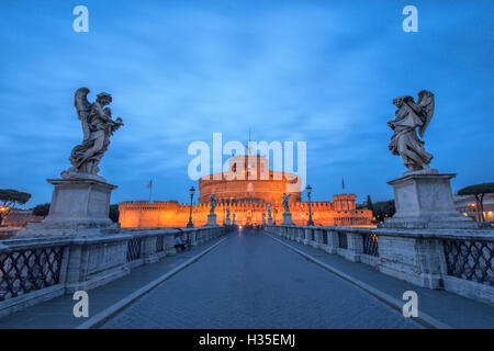 Dusk on the ancient palace of Castel Sant'Angelo with statues of angels on the bridge on Tiber RIver, UNESCO, Rome, Lazio, Italy Stock Photo