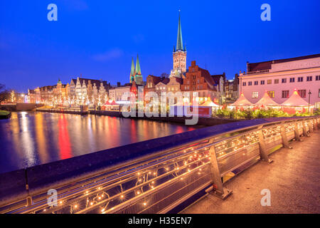 Night view of typical houses and the cathedral reflected in River Trave, Lubeck, Schleswig Holstein, Germany Stock Photo
