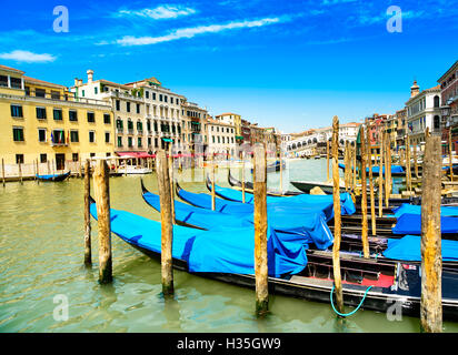 Venice grand canal, gondolas or gondole and Rialto bridge on background. Italy Stock Photo