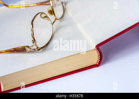 Glasses Lying On The Open Book Stock Photo