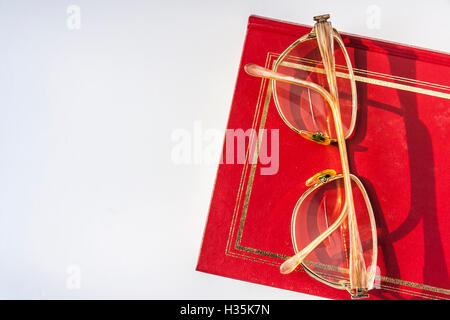 Reading Glasses Lying On The Red Book Stock Photo