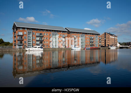 England UK  New build apartment blocks sitting waterside on the main basin of Gloucester Docks Stock Photo