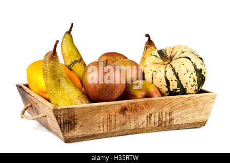 Isolated basket full of autumn fruits with apples, pears and pumpkin Stock Photo