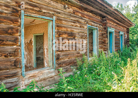 log wall of old abandoned wooden house on sunny summer day Stock Photo