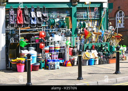 English hardware homeware shop with large quantity of stock hanging from shop front window and placed on pavement in Nuneaton West Midlands England UK Stock Photo