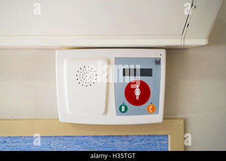 Nurse call emergency red button in hospital room. Stock Photo