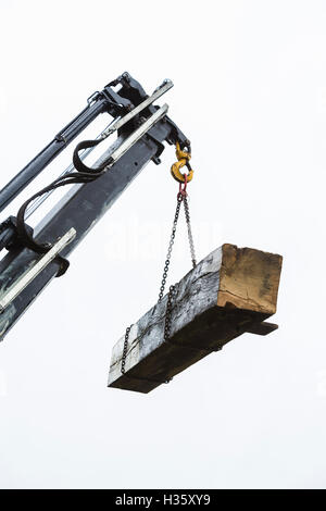 A set of lock gates is removed by the Canal & River trust -  to be replaced by new ones on the Grand Union canal at Stockton, Warwickshire, UK. PICTURED HERE: One of the old lock gate beams is removed and hosited away. Stock Photo