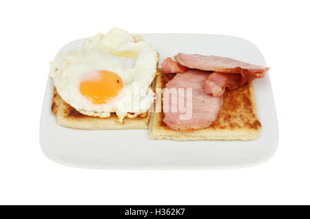 Fried egg, bacon and Irish potato bread on a plate isolated against white Stock Photo