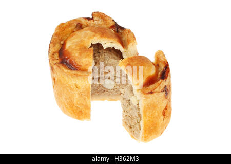 Handmade hot water crust pork pie with a slice cut out isolated against white Stock Photo
