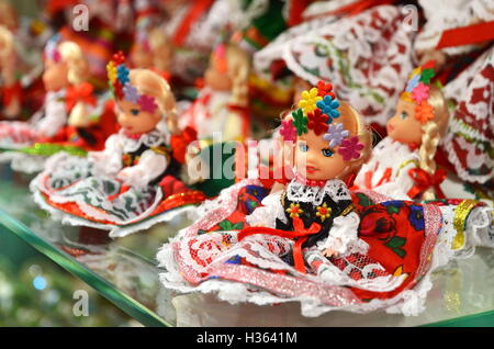 KRAKOW, POLAND - JULY 5, 2016: Vendor sells Polish traditional handicraft souvenirs in Sukiennice (Cloth Hall). Stock Photo