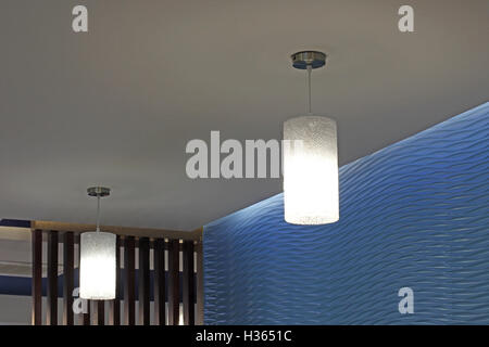 modern hanging lamp with light on ceiling Stock Photo