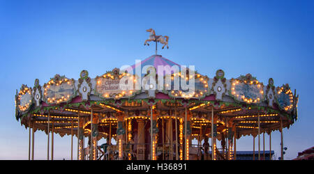 Retro carousel illuminated at night, blue hour Stock Photo