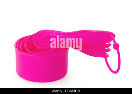 Pink measuring cups isolated on white background Stock Photo