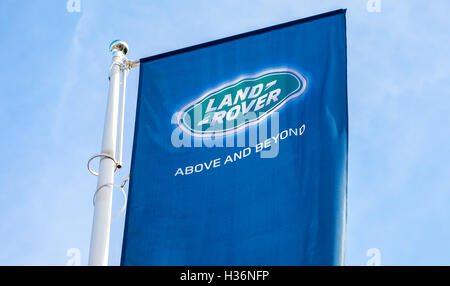 Official dealership flags of Land Rover against the blue sky background. Stock Photo