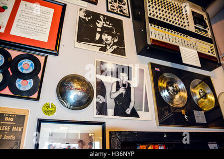 Memorabilia celebrating albums, photos & Equipment & musical artists exhibited on wall inside Sun Record Studio In Memphis TN Stock Photo