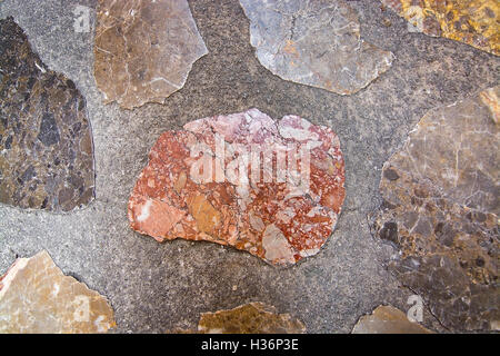 Pavement brecchia stone background texture warm tones. Stock Photo