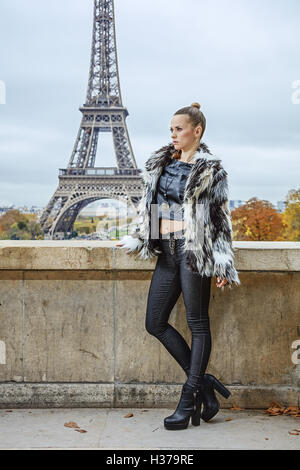 Bold winter in Paris. Full length portrait of modern fashion-monger in fur coat in Paris, France looking into the distance Stock Photo