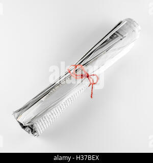 Newspaper Rope rolled up newspaper focus on red rope on a white background Stock Photo ...