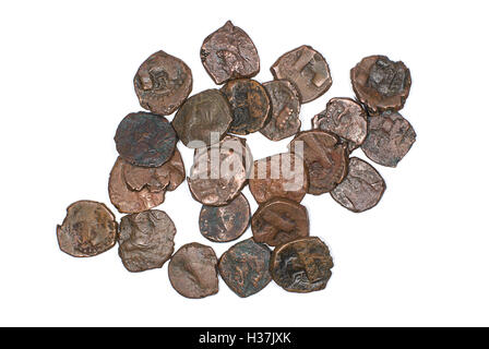 Many ancient bronze coins on white Stock Photo