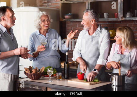 Big family having a conversation in the kitchen Stock Photo