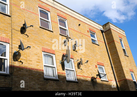 Satellite dishes attached to a block of flats, East London, UK Stock Photo