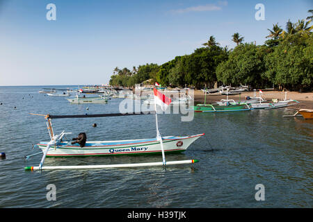 Indonesia, Bali, Lovina, fishing boats on main beach and moored in sea Stock Photo