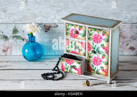 A hand made decoupaged jewellery armoire in a shabby chic pink floral design Stock Photo