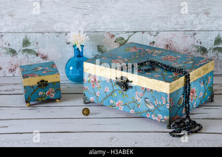 Hand made vintage style jewellery boxes on a rustic background Stock Photo