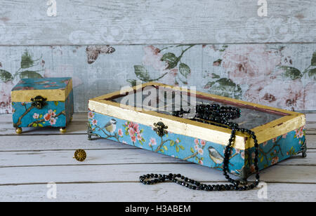 Beautiful hand made jewelley boxes decoupaged in vintage paper and gilded with gold leaf Stock Photo